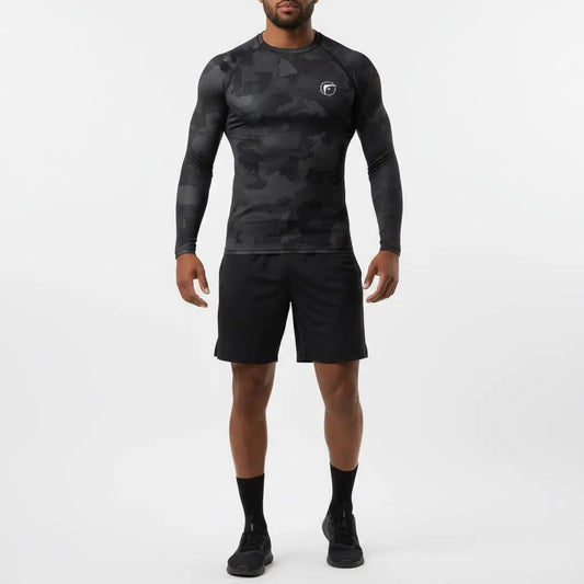 Full-body view of athlete wearing Shadow Strike Camo long-sleeve boxing compression shirt with black camouflage pattern and black shorts