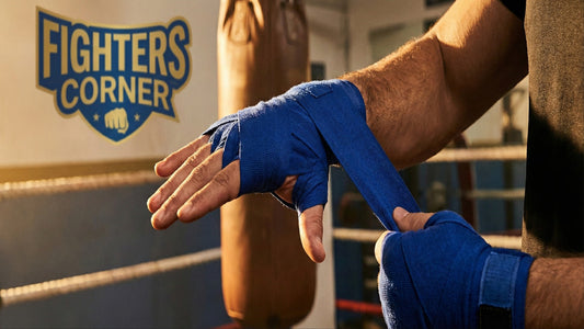Close-up of a boxer wrapping blue hand wraps around the wrist in a gym
