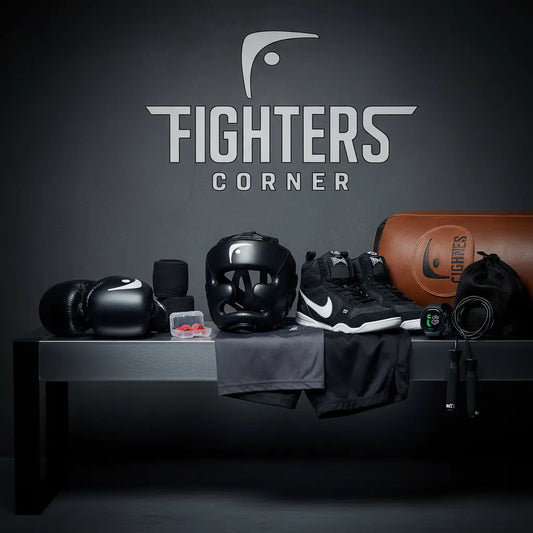 Collection of boxing gear including gloves, wraps, and pads laid out on a bench.