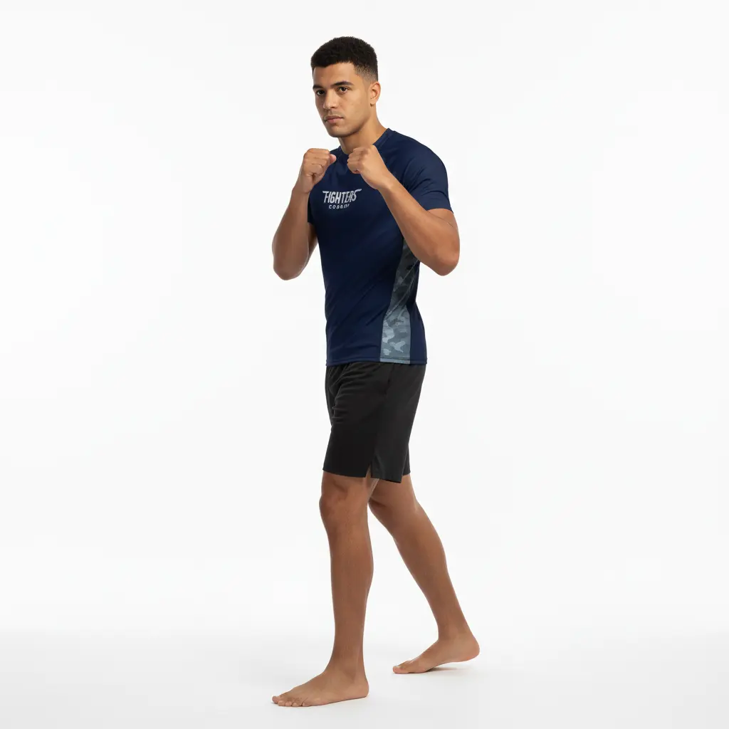 Male boxer wearing navy blue rash guard and black shorts — Fighters Corner.