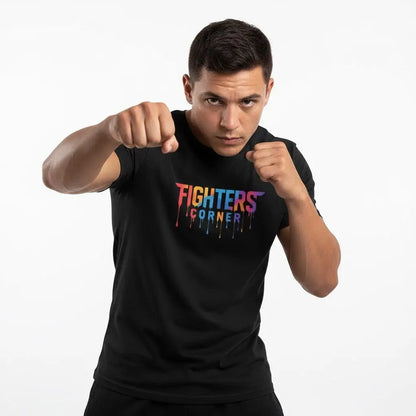 Front view of man posing in black Fighters Corner t-shirt with colorful logo and fists clenched on white background.