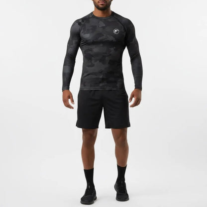 Full-body view of athlete wearing Shadow Strike Camo long-sleeve boxing compression shirt with black camouflage pattern and black shorts