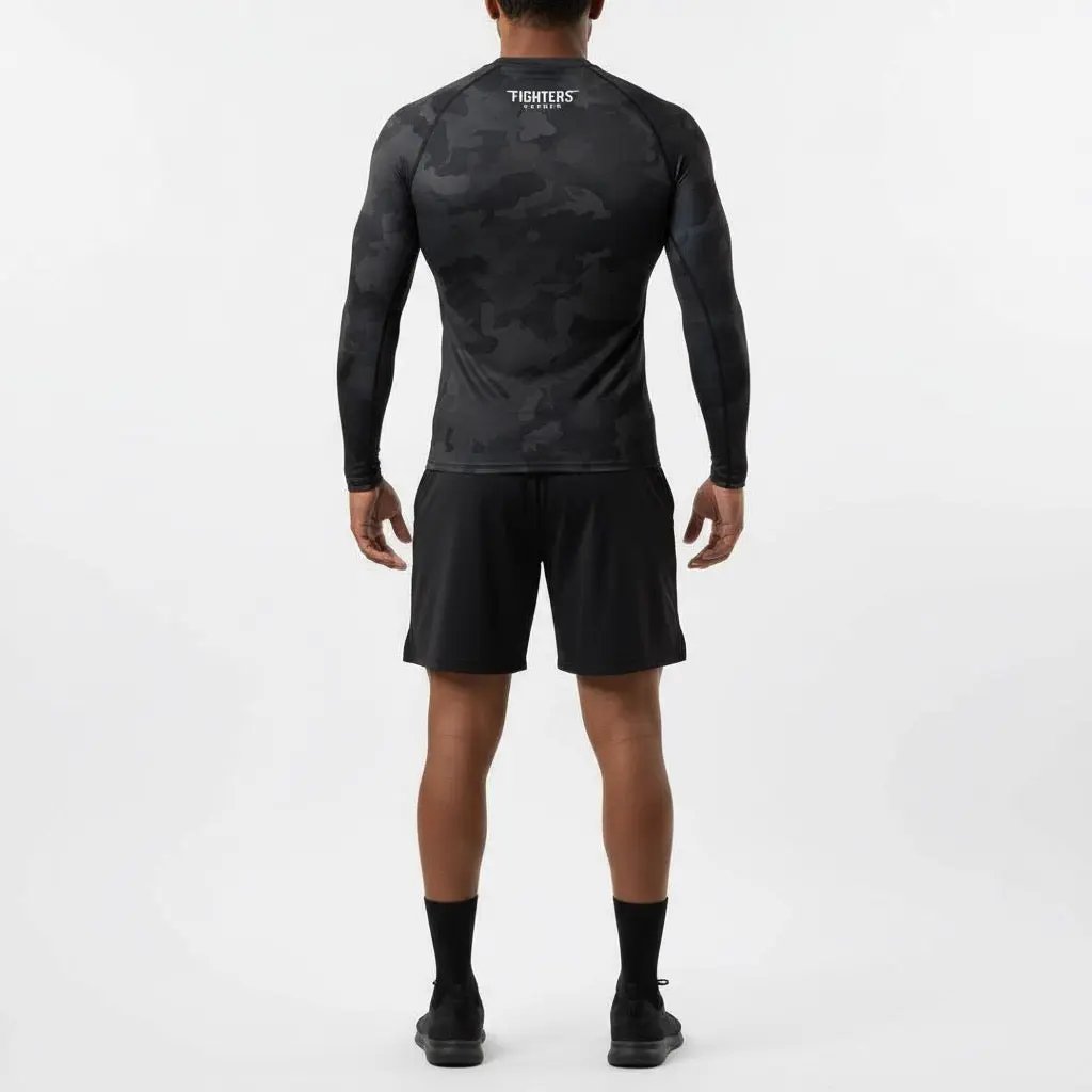 Person wearing a black camouflage long-sleeve shirt and shorts on a white background