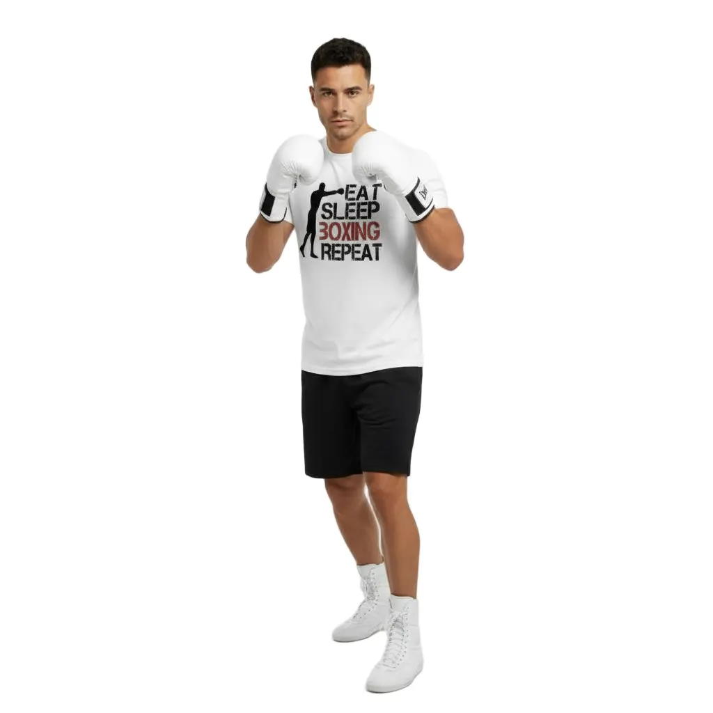 Full-body view of man wearing white 'Eat Sleep Boxing Repeat' T-shirt by Fighters Corner, black shorts, and boxing gloves.