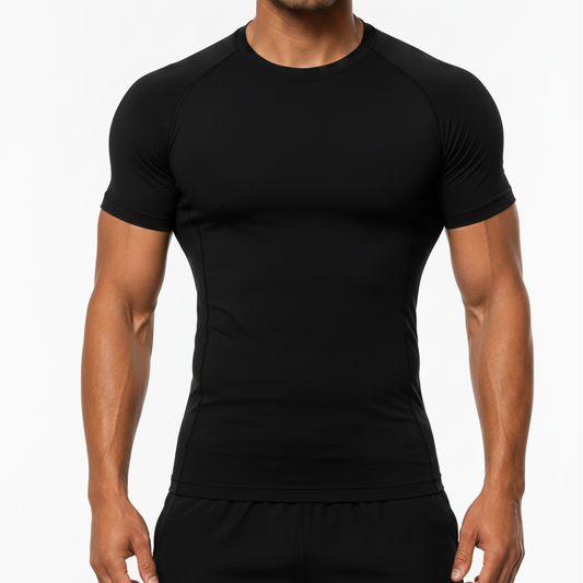 A man wearing a tight-fitting black short-sleeve athletic compression shirt and black pants, standing against a plain light background.